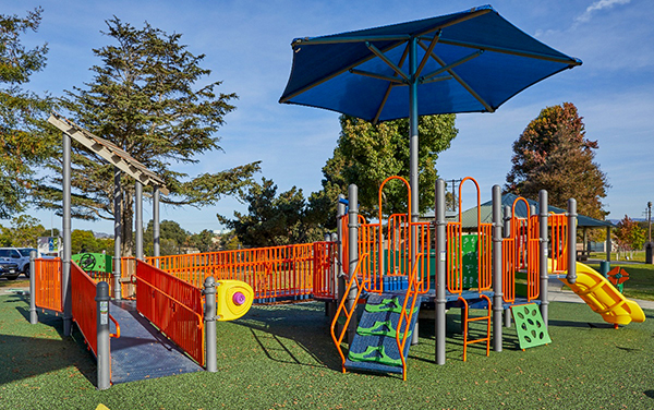 Aerial view of large elevated aluminum grandstand next to a blue running track.