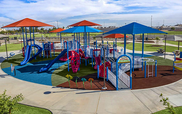 Aerial view of large elevated aluminum grandstand next to a blue running track.