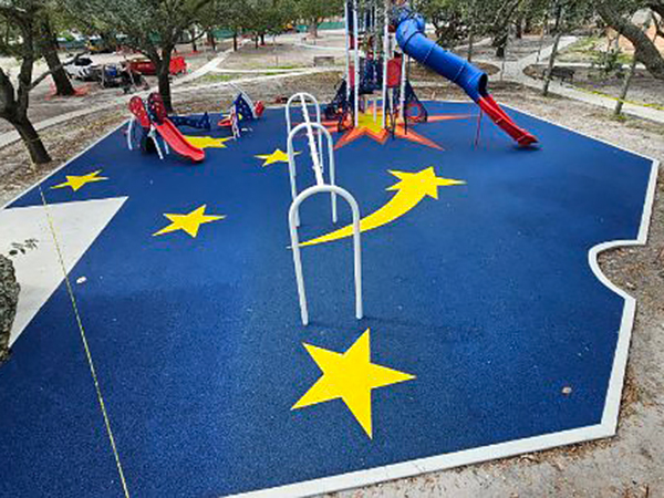 Rocket-themed poured-in-place rubber safety surfacing with star and comet graphics at Scott Park, Miami Gardens, Florida, Bliss Products and Services