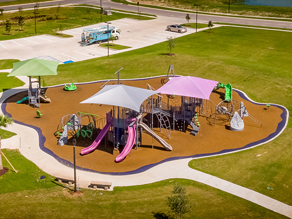 Aerial view of the Lakeshore Villages playground in Slidell, Louisiana with integrated shade structures and safety surfacing, Bliss Products and Services.