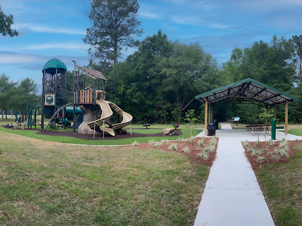 Playground with slides and rubber surfacing beside a covered pavilion at Woodville Park in Tallahassee, Florida, Bliss Products and Services