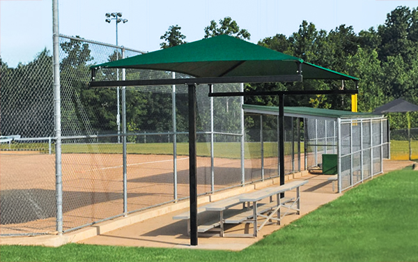 Baseball dugout with shade canopy and bench seating along the fence line | Bliss Products and Services
