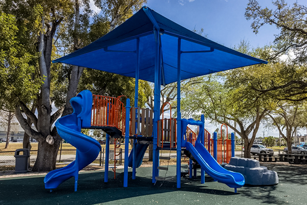 Double slide playground structure under shade cover in Cape Coral Florida park