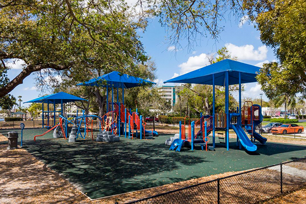 Wide view of playground with multiple shade structures in Cape Coral Florida