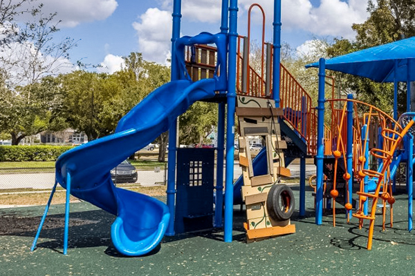 Spiral slide and access platform on shaded playground structure in Cape Coral Florida