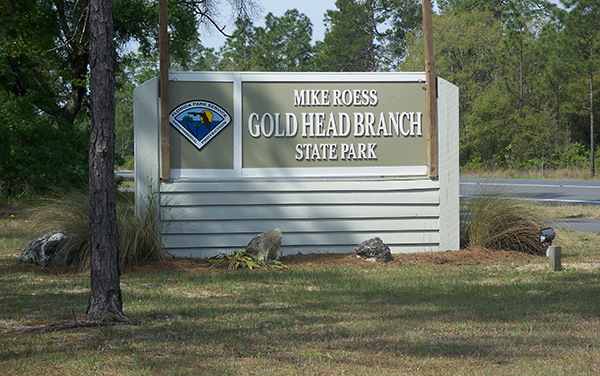 Entrance sign for Mike Roess Gold Head Branch State Park in Clay County, Florida