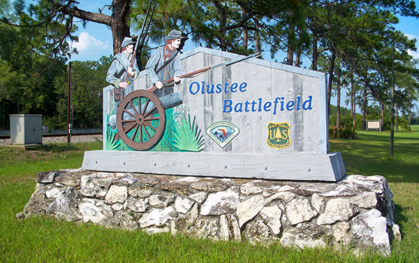Olustee Battlefield Historic State Park sign in Baker County, Florida, representing historic outdoor spaces near Sanderson.