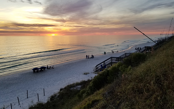 Sunset over white sand beach in Walton County Florida