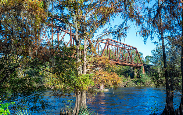Flint River and rail bridge in Albany Georgia representing Dougherty County and Southwest Georgia communities served by Bliss Products and Services