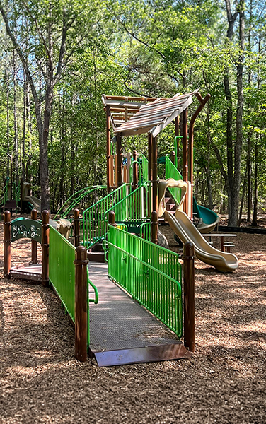 Double slide playground structure under shade cover in Cape Coral Florida park
