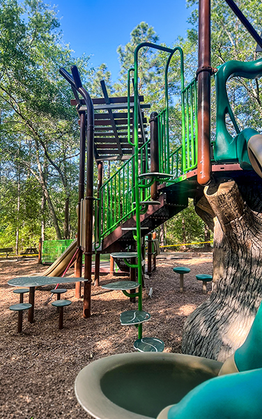 Wide view of playground with multiple shade structures in Cape Coral Florida