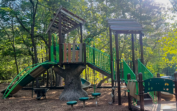 Spiral slide and access platform on shaded playground structure in Cape Coral Florida