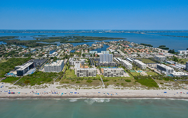Aerial view of Cocoa Beach near Lori Wilson Park in Brevard County, Florida with beach, coastal neighborhoods, waterways, and Thousand Islands in the background.
