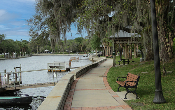 Waterfront walkway and benches at Cotee River Park in New Port Richey, Pasco County, Florida.