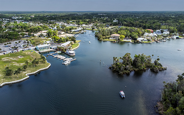 Aerial view of Kings Bay in Crystal River, Florida with waterfront areas, boats, homes, green space, and natural waterways.