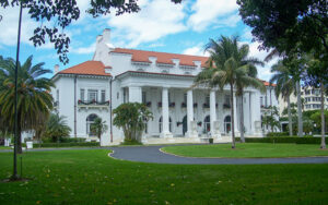 Whitehall, the Flagler Museum in Palm Beach, Florida, with palm trees, lawn, and historic architecture in Palm Beach County.