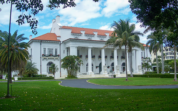 Whitehall, the Flagler Museum in Palm Beach, Florida, with palm trees, lawn, and historic architecture in Palm Beach County.