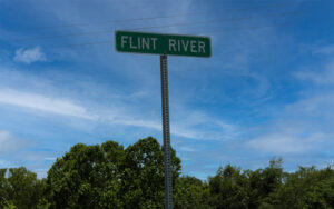 Flint River sign along GA 37 in Baker County, Georgia, representing the county’s river corridor for Bliss Products and Services.
