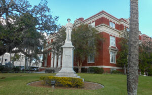 Historic Hernando County Courthouse with a foreground monument in Brooksville, Florida.