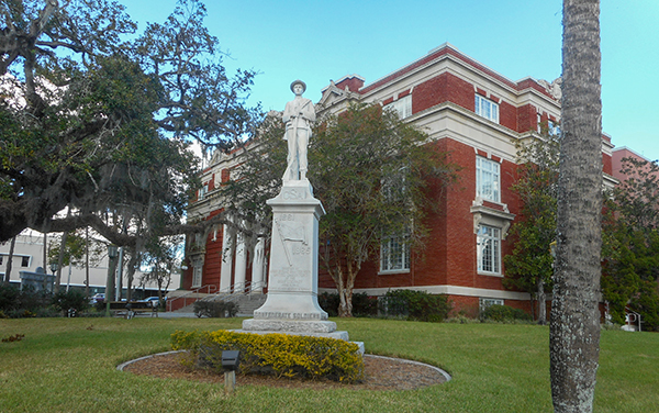 Historic Hernando County Courthouse with a foreground monument in Brooksville, Florida.