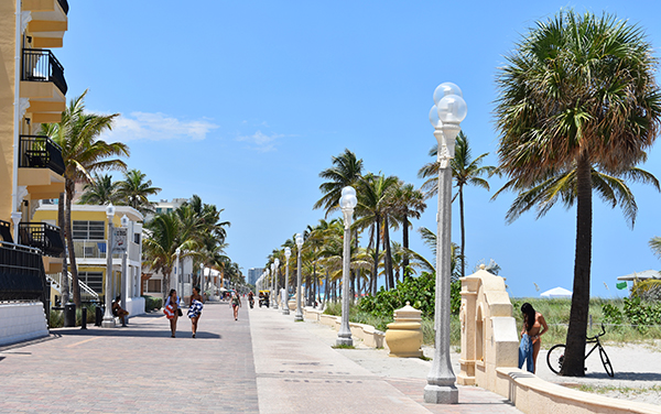Palm-lined Hollywood Beach Broadwalk beside the beach in Hollywood, Florida, representing coastal communities in Broward County.