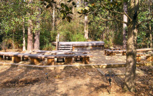 Kennedy Outdoor Classroom at Georgia Southern Botanical Garden in Statesboro, Georgia, showing outdoor seating in a wooded learning space.