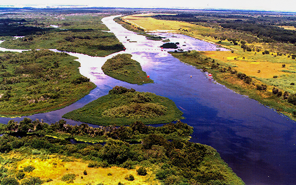Aerial view of the Kissimmee River canal section in central Florida, representing the rural water landscape around Okeechobee County.