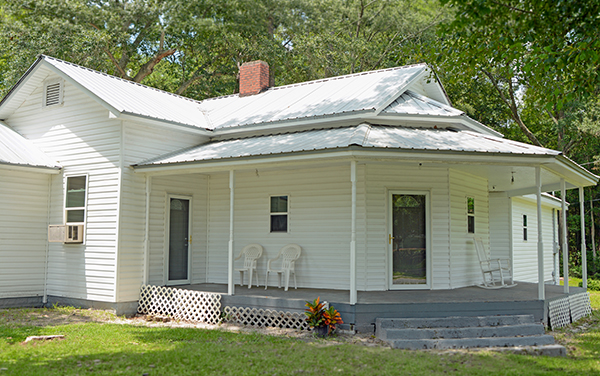 White house on Main Street in Baxley, Georgia, representing residential community character in Appling County for Bliss Products and Services.