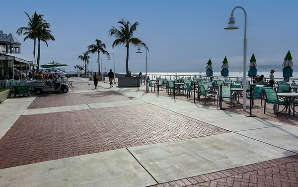 Mallory Square waterfront in Key West, Florida, with palm trees, seating, paved gathering space, and ocean views in Monroe County.