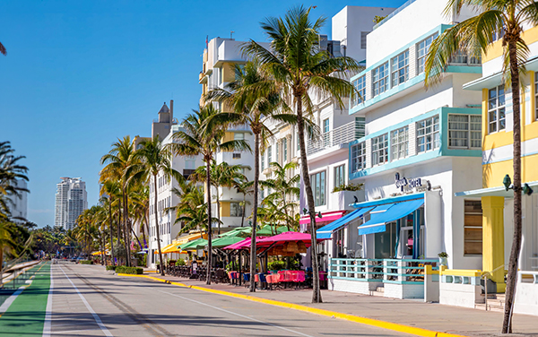 Ocean Drive in Miami Beach, Florida, with Art Deco buildings, palm trees, cafes, and streetscape in Miami-Dade County.