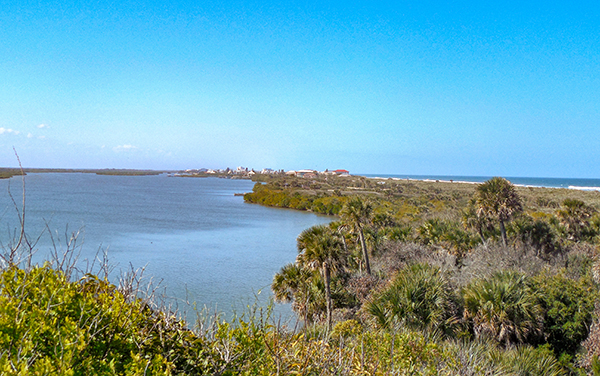 New Smyrna Beach Inlet with shoreline and coastal water views in Volusia County, Florida.