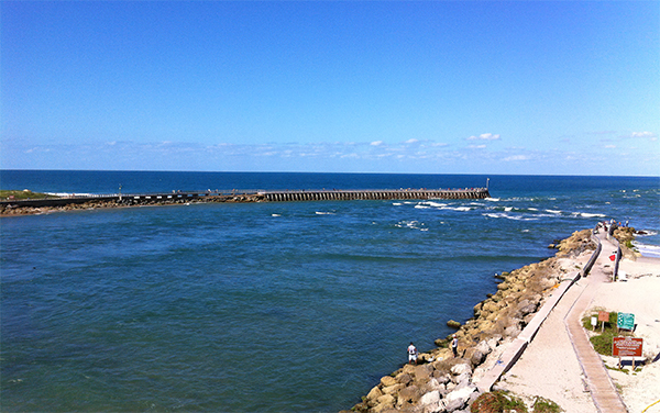 View of Sebastian Inlet with jetties and ocean water near Brevard County, Florida.