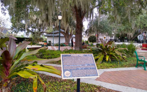 Sunset Park in Mount Dora, Lake County, Florida, with landscaped walkways, benches, and mature trees.
