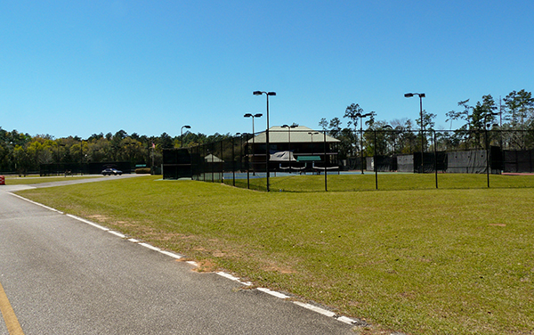 Fenced tennis courts and sports lighting at Bill Reynolds Sports Park in Bainbridge, Georgia