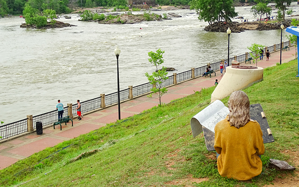 Chattahoochee RiverWalk with benches, railings and pedestrians beside the river in Columbus, Georgia