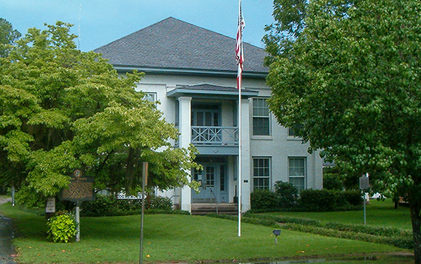 Clay County Courthouse in Fort Gaines, Georgia, surrounded by trees and landscaped grounds.