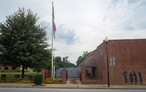 Flags, landscaped entrance and memorial artwork at Colquitt Veterans Park in Colquitt, Georgia