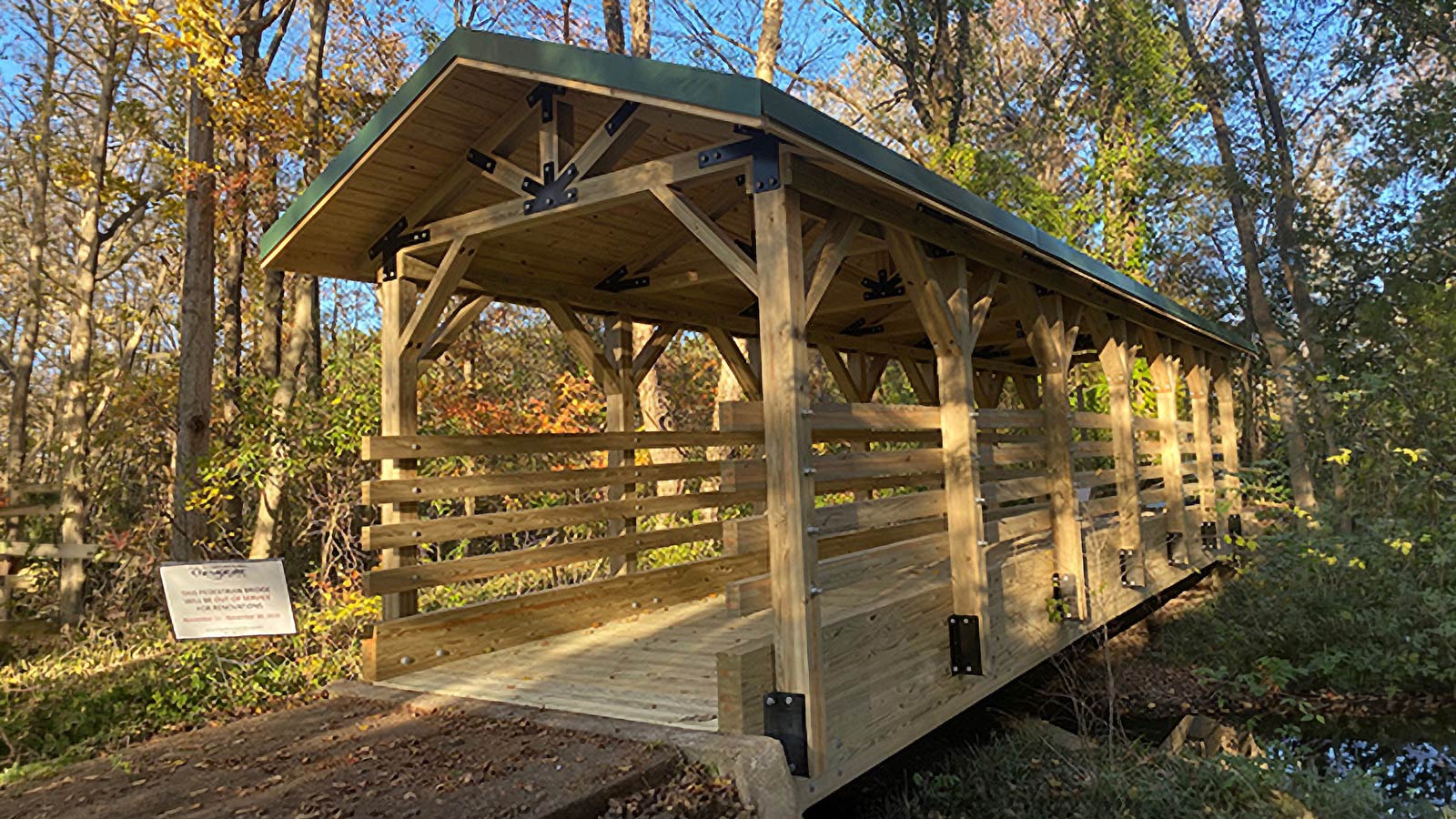 Timber covered pedestrian bridge in the wooded grounds of Chesapeake City Hall in Virginia