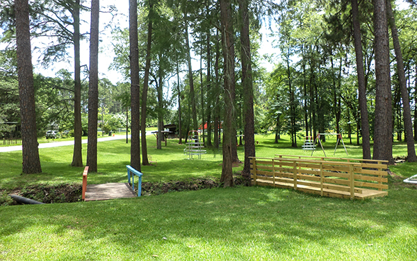 Wooden footbridges, open lawn and recreation area at Cumbee Park in Ocilla, Georgia