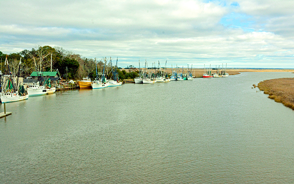 Shrimp boats moored along the Darien River beside coastal marshes in McIntosh County, Georgia