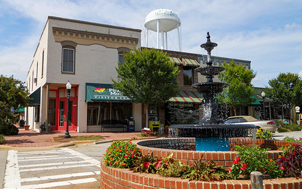 Landscaped fountain and historic storefronts in downtown Pine Mountain, Georgia