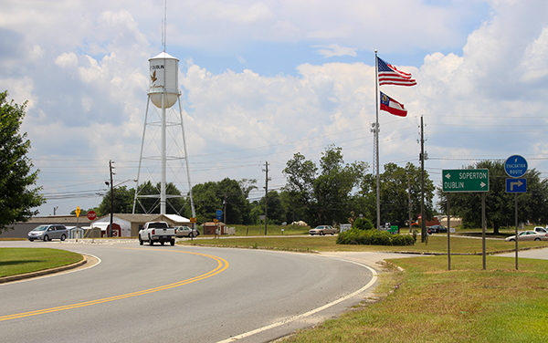 East Dublin water tower, flags and highway signs in Laurens County, Georgia