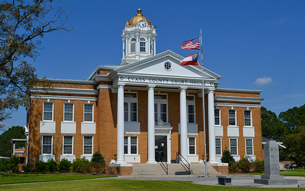 Historic Evans County Courthouse with clock tower and white columns in Claxton, Georgia