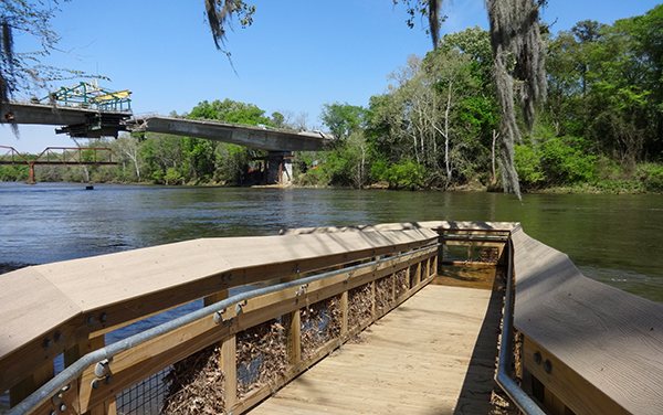 Accessible wooden ramp leading to the Flint River at Riverfront Park in Albany, Georgia