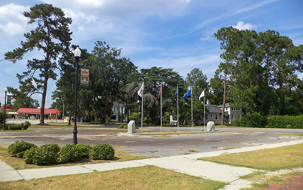 Landscaped Freedom Plaza with flagpoles and public walkways in downtown Pelham, Georgia