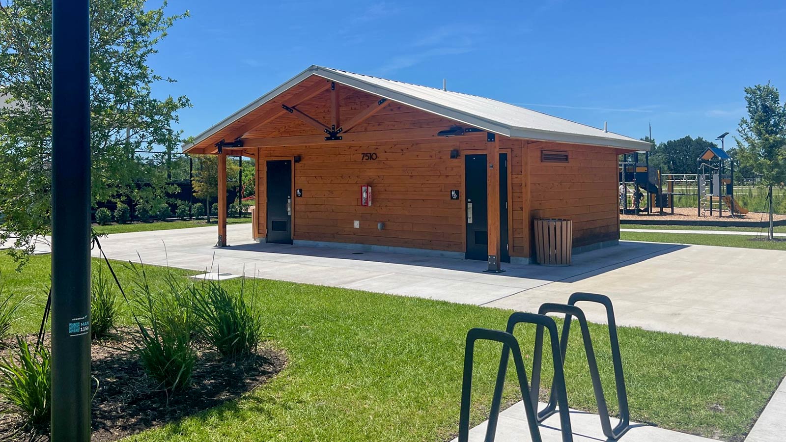 Wood-clad restroom building at Governor Ron DeSantis Park in Florida