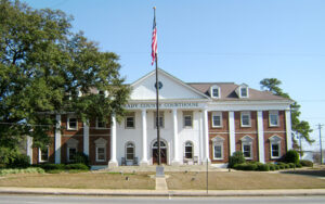 Historic Grady County Courthouse with white columns and landscaped grounds in Cairo, Georgia