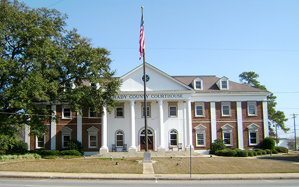 Historic Grady County Courthouse with white columns and landscaped grounds in Cairo, Georgia