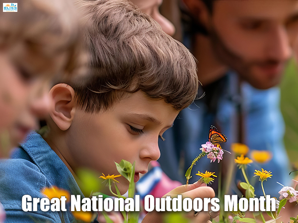 Child smelling wildflowers outdoors with Great Outdoors Month text