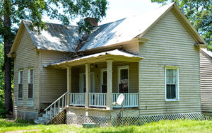 Historic Harris-Murrow-Trowell House with front porch and pale siding in Oliver, Screven County, Georgia